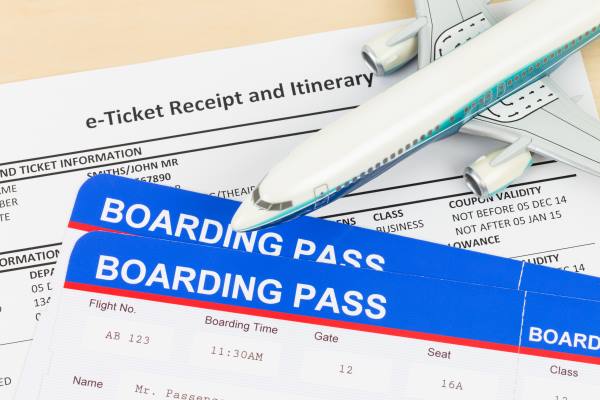 E-ticket with plane model, and boarding pass; ticket and boarding pass are mock-up