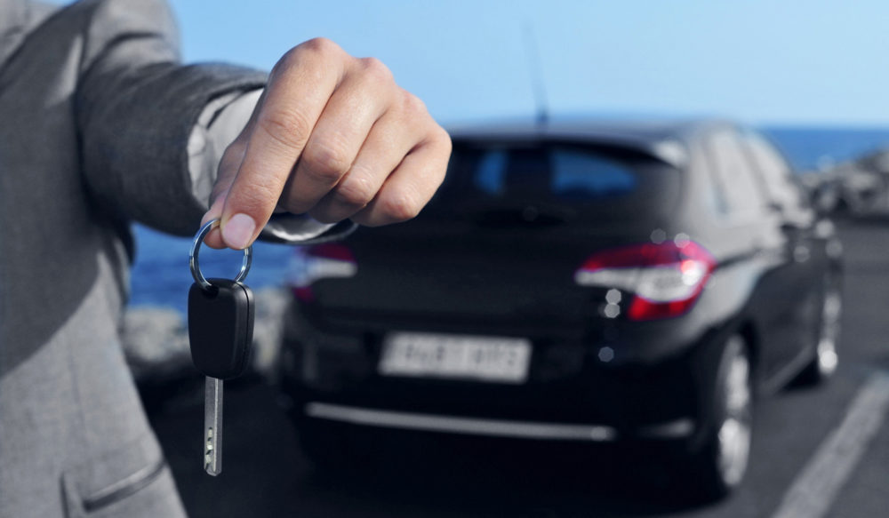 man offering a car key to the observer
